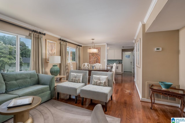 living room featuring wood-type flooring and ornamental molding