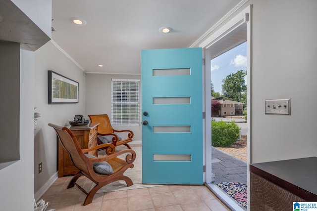 tiled entryway featuring ornamental molding