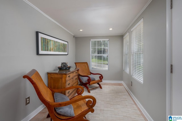 sitting room with a healthy amount of sunlight and crown molding