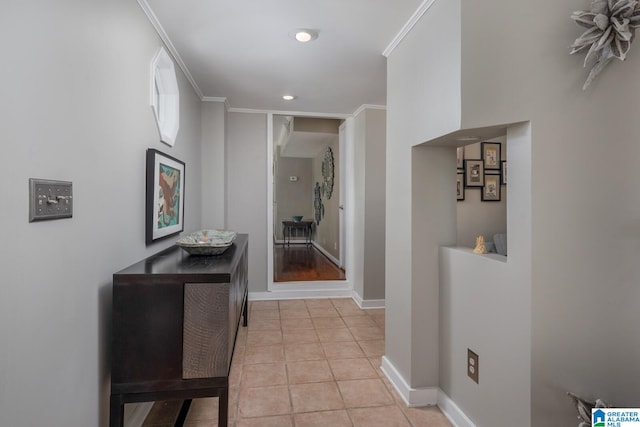 corridor featuring crown molding and light hardwood / wood-style flooring