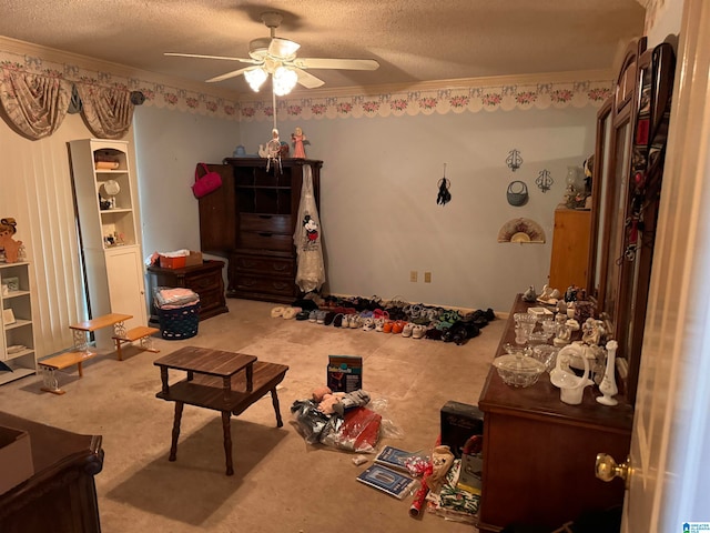 carpeted bedroom with ceiling fan, a textured ceiling, and ornamental molding