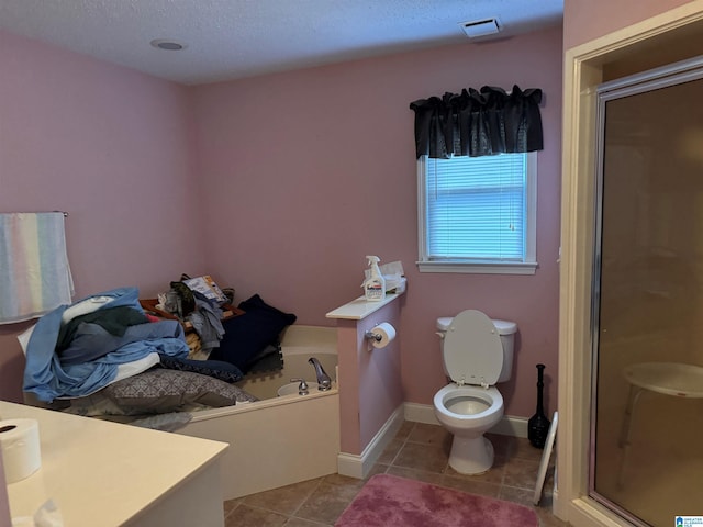 bathroom featuring separate shower and tub, a textured ceiling, toilet, and tile patterned floors