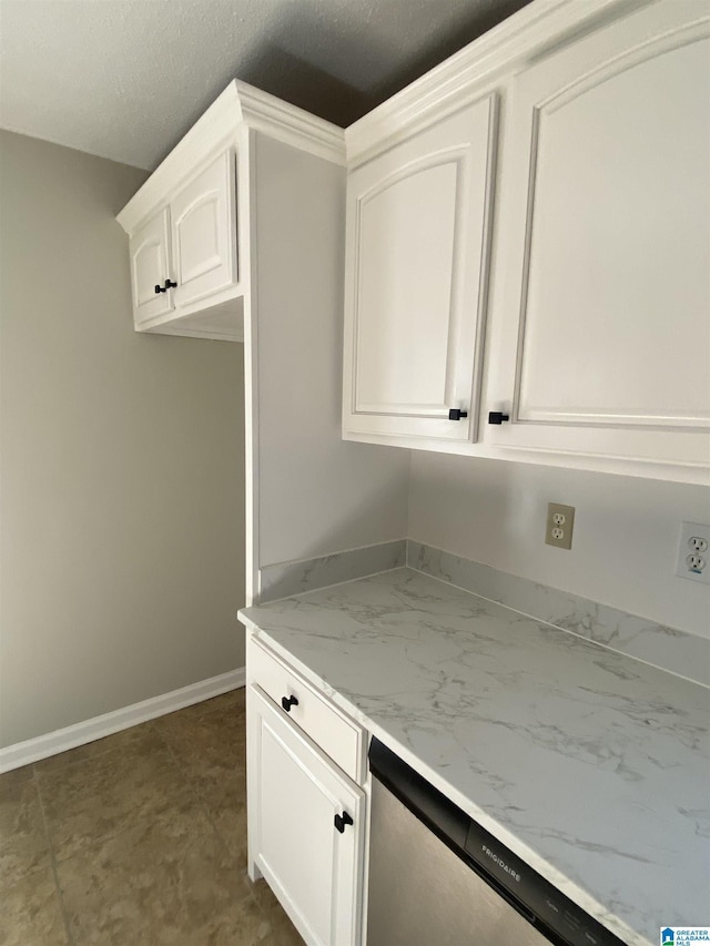 kitchen with dishwasher, light stone countertops, and white cabinets