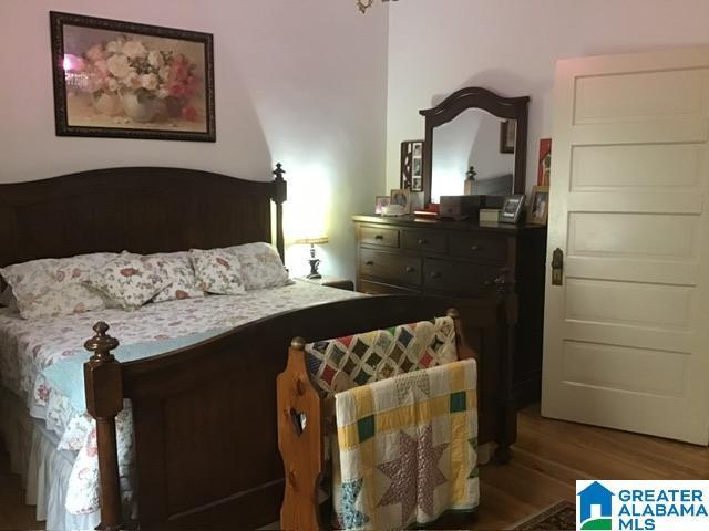 bedroom with dark wood-type flooring