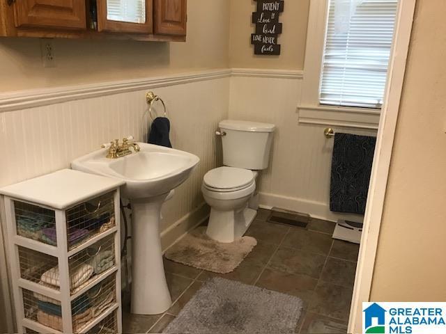 bathroom featuring tile patterned floors, toilet, and baseboard heating