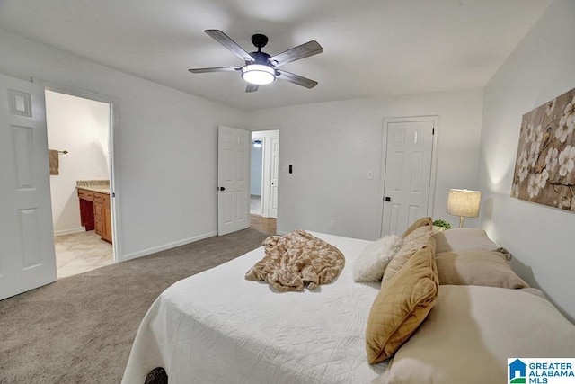 bedroom with light carpet, ensuite bath, baseboards, and ceiling fan