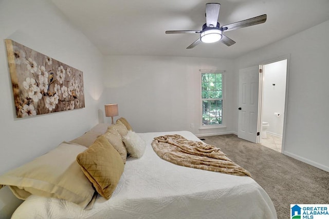 bedroom featuring light carpet, ceiling fan, baseboards, and connected bathroom