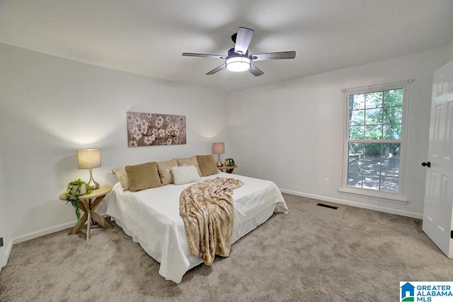 bedroom with light carpet and ceiling fan