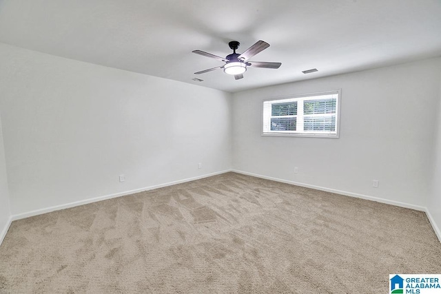 unfurnished room featuring light carpet, baseboards, visible vents, and ceiling fan