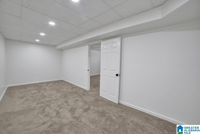 finished basement featuring carpet, a drop ceiling, baseboards, and recessed lighting