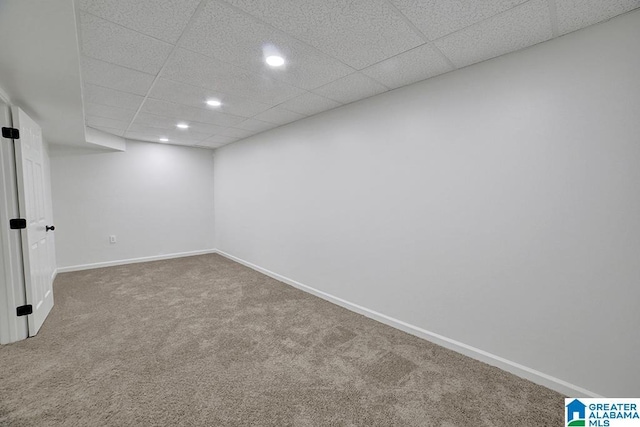 finished below grade area with carpet, a drop ceiling, baseboards, and recessed lighting