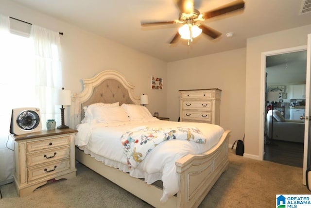 bedroom with ceiling fan and light colored carpet