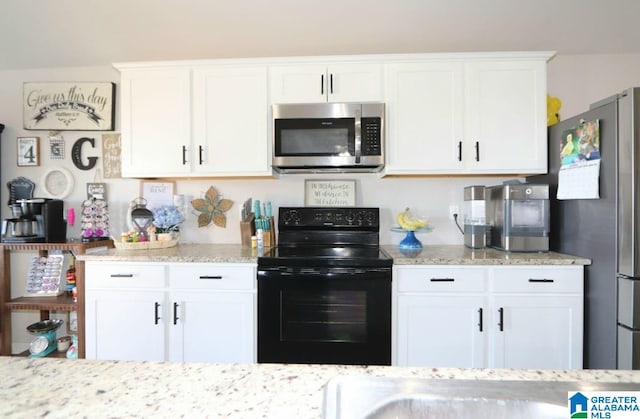 kitchen featuring white cabinetry, stainless steel appliances, and light stone countertops