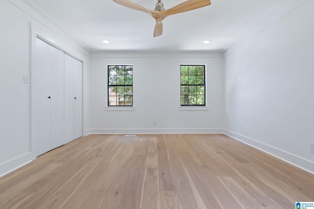 unfurnished bedroom featuring a closet, light hardwood / wood-style flooring, ornamental molding, and ceiling fan