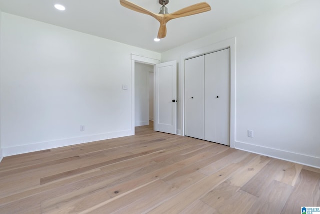 unfurnished bedroom with light hardwood / wood-style floors, a closet, and ceiling fan