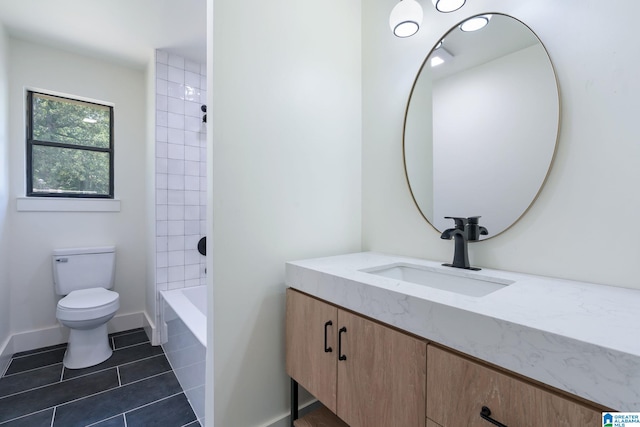 full bathroom featuring tile patterned flooring, toilet, vanity, and tiled shower / bath