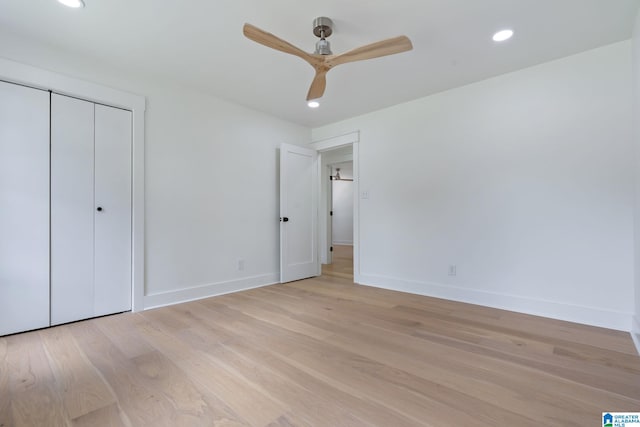 unfurnished bedroom with light hardwood / wood-style floors, a closet, and ceiling fan