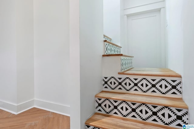 stairway with light parquet flooring