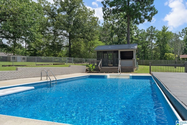 view of swimming pool with an outbuilding