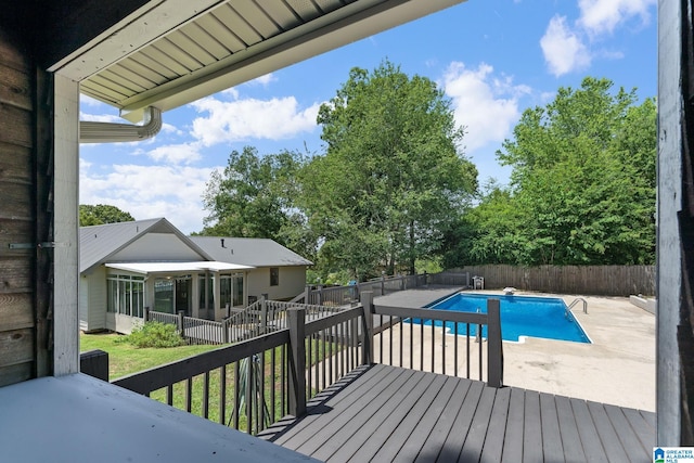 view of pool featuring a patio area, a deck, and a diving board