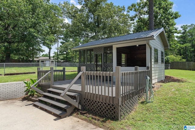 view of front of home with a front lawn and a wooden deck