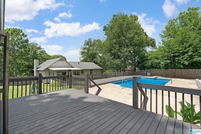 view of swimming pool with a wooden deck and a patio area