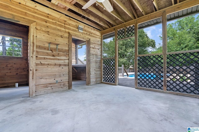 unfurnished sunroom featuring ceiling fan