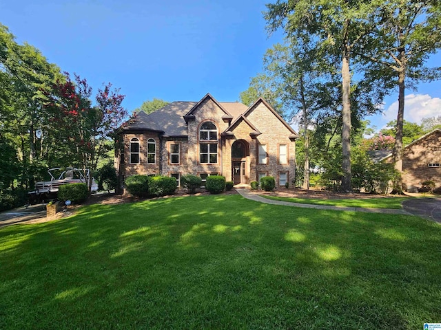 french country style house with a front yard