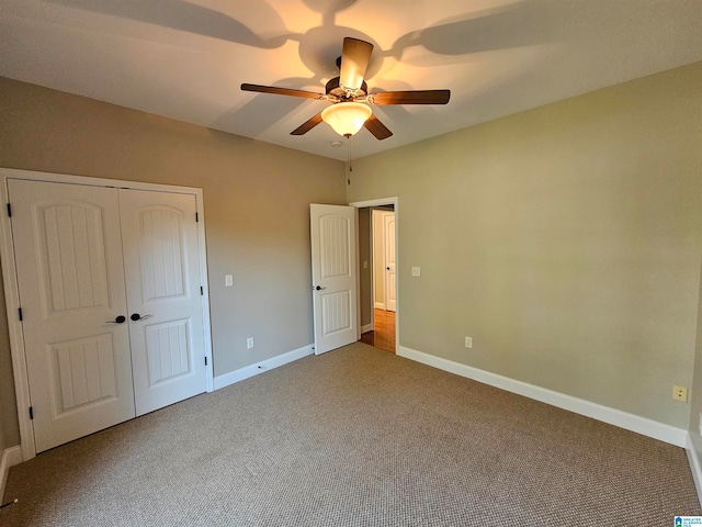 unfurnished bedroom featuring a closet, carpet flooring, and ceiling fan