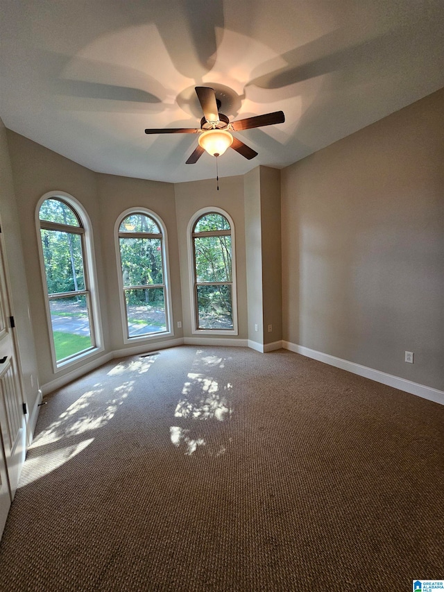 spare room featuring carpet flooring and ceiling fan