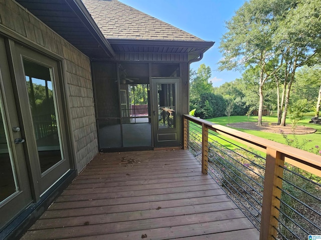 wooden terrace featuring a yard