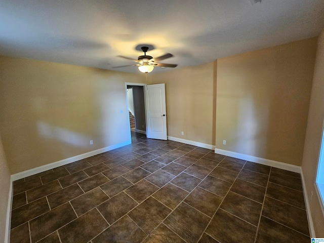 tiled empty room with ceiling fan