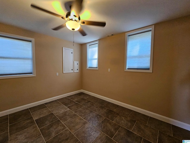 tiled empty room with ceiling fan