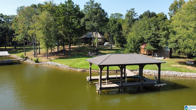 view of dock featuring a water view and a yard