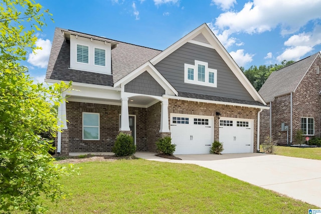 craftsman house with a garage and a front lawn