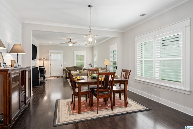 dining room with ornamental molding, plenty of natural light, dark hardwood / wood-style floors, and ceiling fan