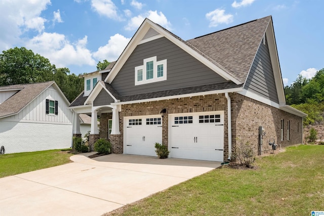 craftsman house featuring a garage and a front lawn