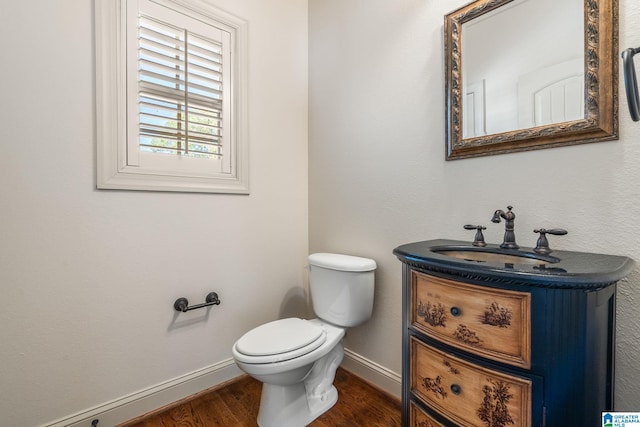 bathroom with vanity, hardwood / wood-style floors, and toilet