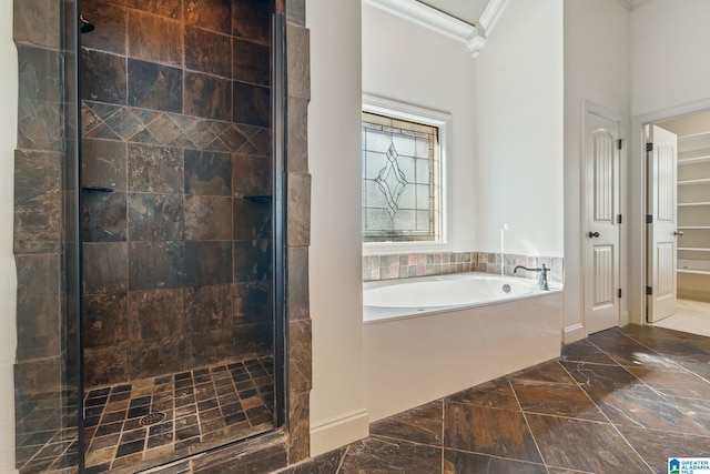 bathroom featuring crown molding and independent shower and bath