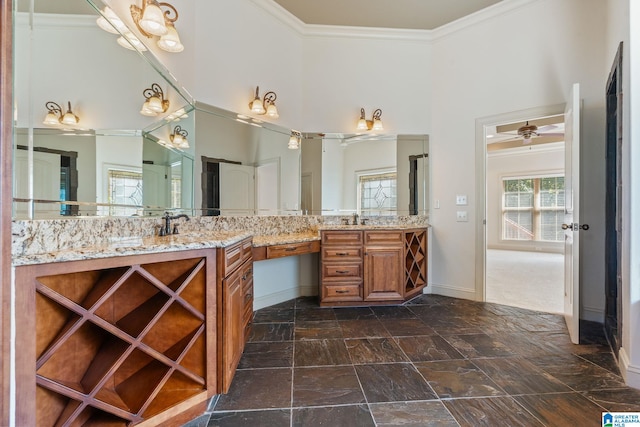 bathroom with ornamental molding, a towering ceiling, and vanity