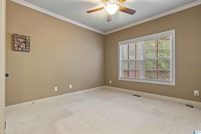 carpeted empty room featuring ceiling fan and ornamental molding