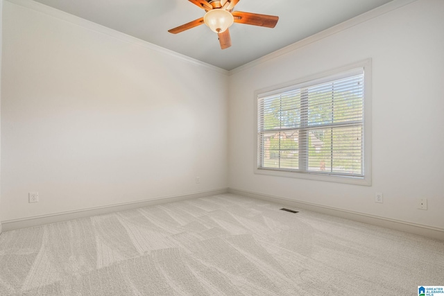 carpeted empty room featuring ornamental molding and ceiling fan