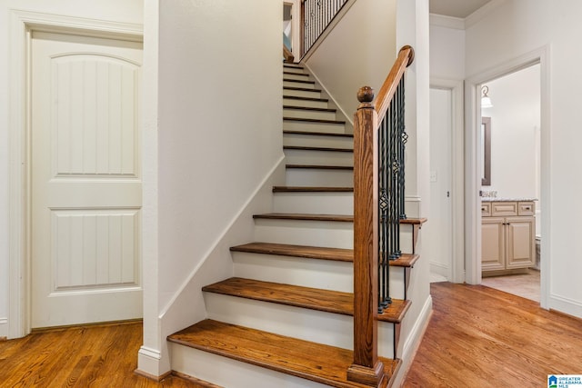 staircase with hardwood / wood-style flooring