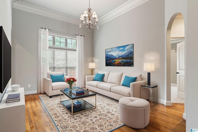 living room featuring ornamental molding, light hardwood / wood-style floors, and a notable chandelier