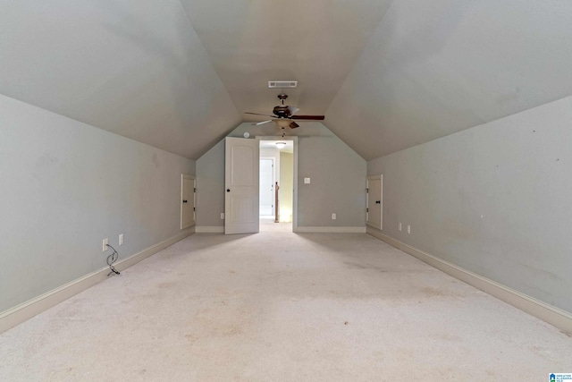 additional living space featuring light carpet, vaulted ceiling, and ceiling fan