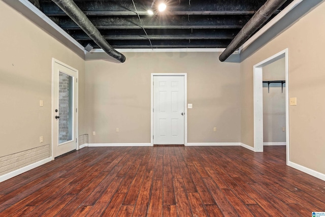 basement with dark hardwood / wood-style floors