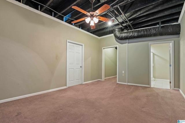 basement with carpet flooring and ceiling fan