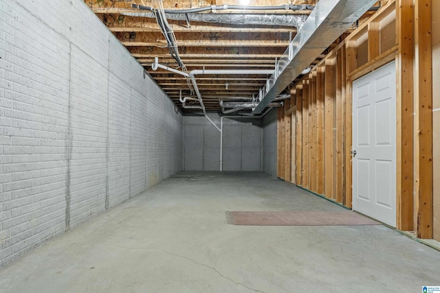 basement with brick wall