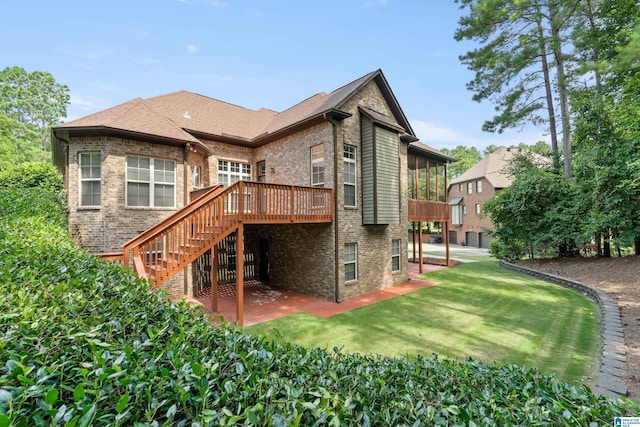 rear view of property with a wooden deck and a lawn