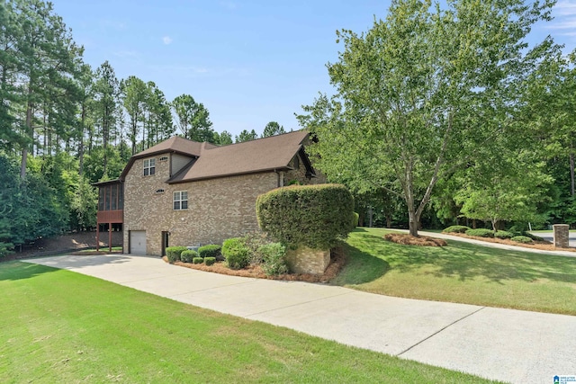 view of front of property featuring a garage and a front lawn